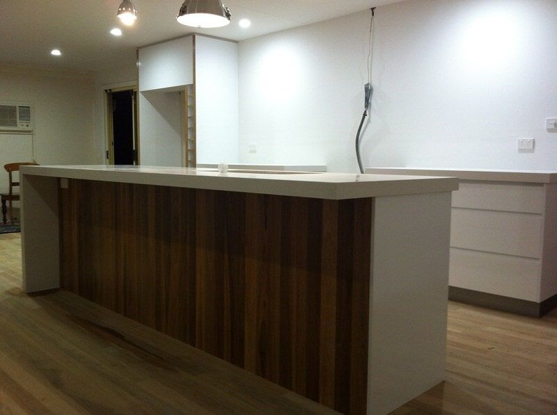 A Kitchen with Wooden Cabinets and White Counter Tops — Burns Custom Kitchens in Newcastle, NSW