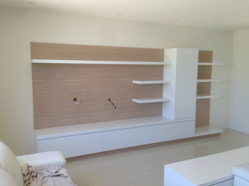 A Living Room with A Couch and Shelves in It — Burns Custom Kitchens in Newcastle, NSW