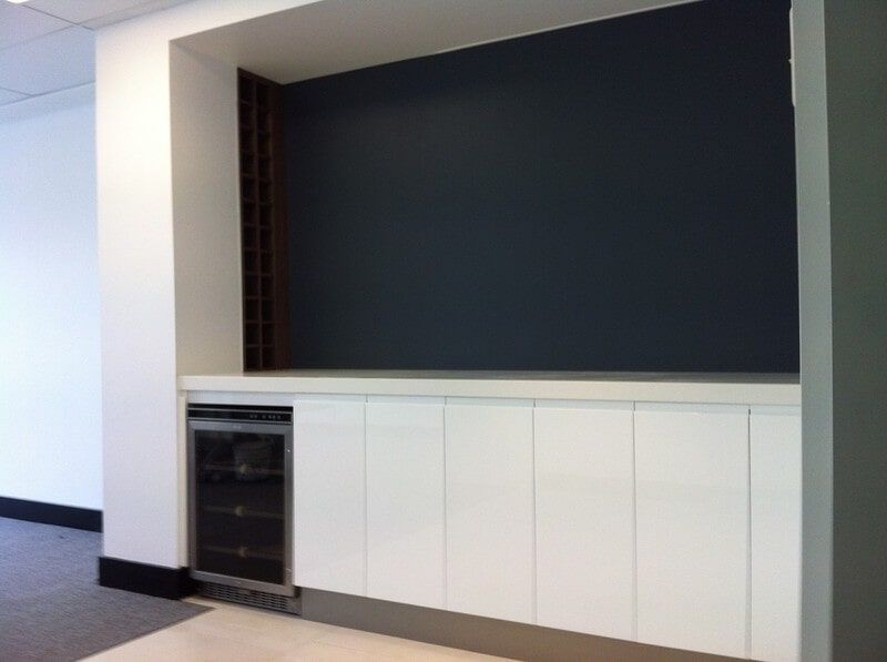 A Kitchen with White Cabinets and A Black Wall — Burns Custom Kitchens in Newcastle, NSW