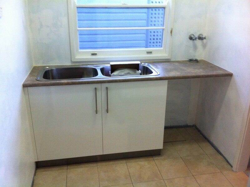 A Kitchen Counter with A Sink and A Window — Burns Custom Kitchens in Newcastle, NSW