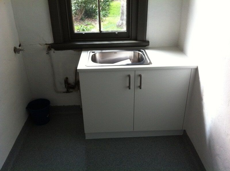 A Kitchen with A Sink and Cabinets and A Window — Burns Custom Kitchens in Newcastle, NSW