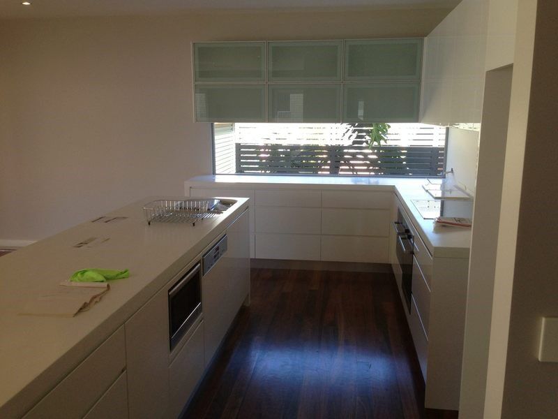 A Kitchen with White Cabinets and A Large Window — Burns Custom Kitchens in Newcastle, NSW