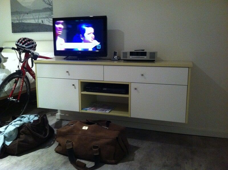 A Bicycle Is Parked in Front of A Flat Screen Tv — Burns Custom Kitchens in Newcastle, NSW