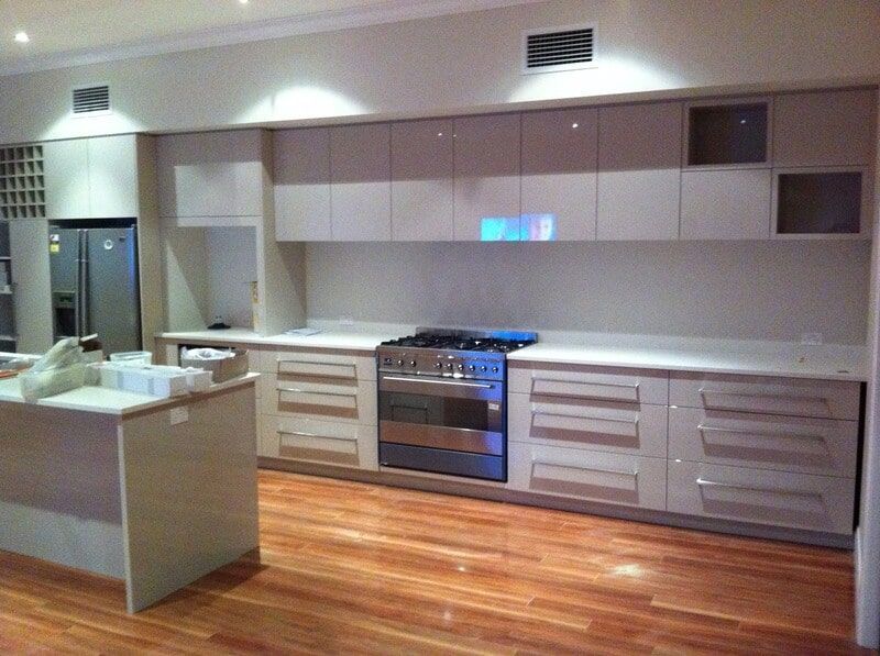 A Kitchen with White Cabinets and Stainless Steel Appliances — Burns Custom Kitchens in Newcastle, NSW