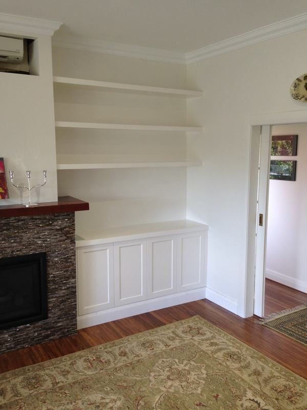 A Living Room with A Fireplace and Built in Shelves — Burns Custom Kitchens in Newcastle, NSW