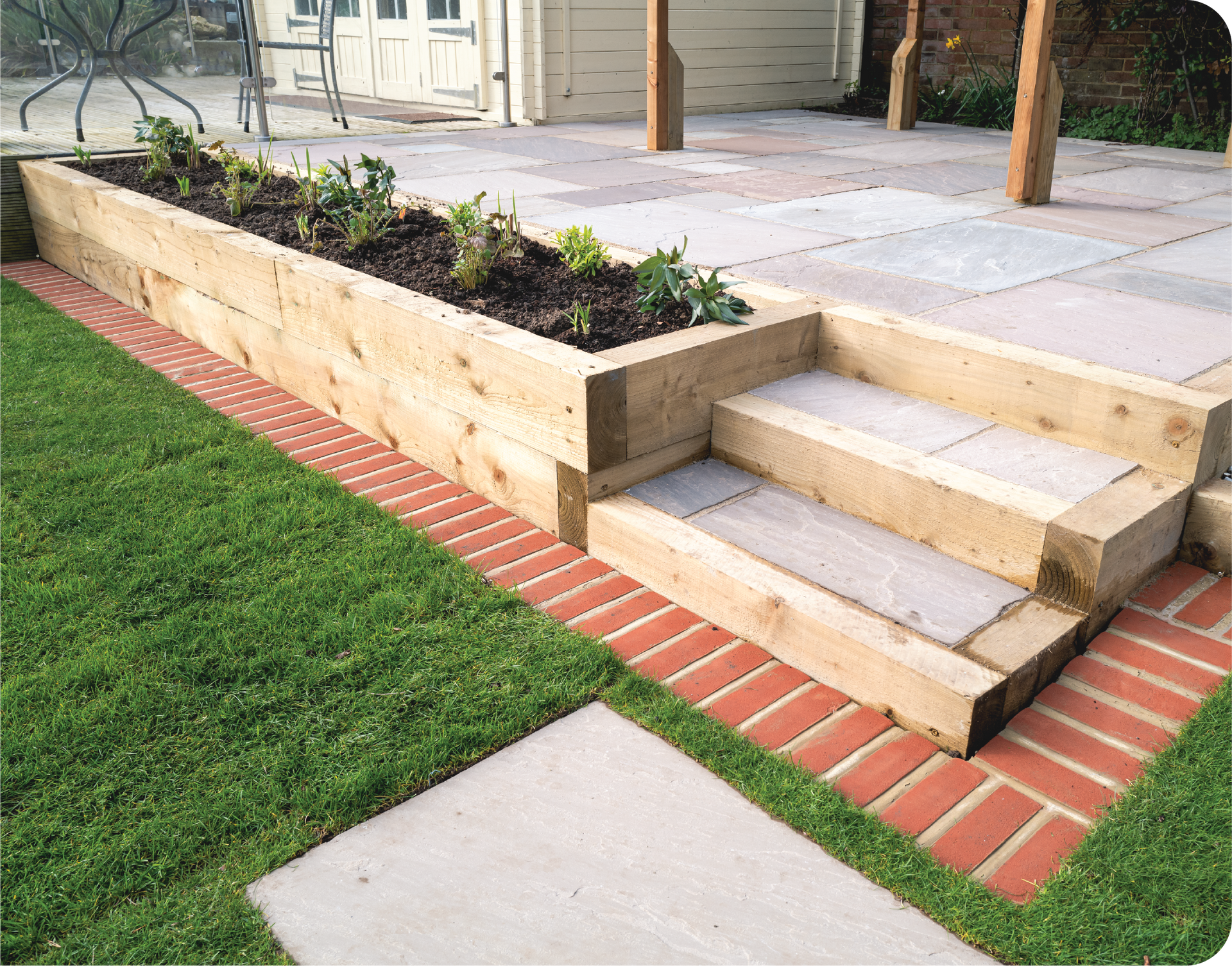 A wooden planter with steps leading up to a patio.