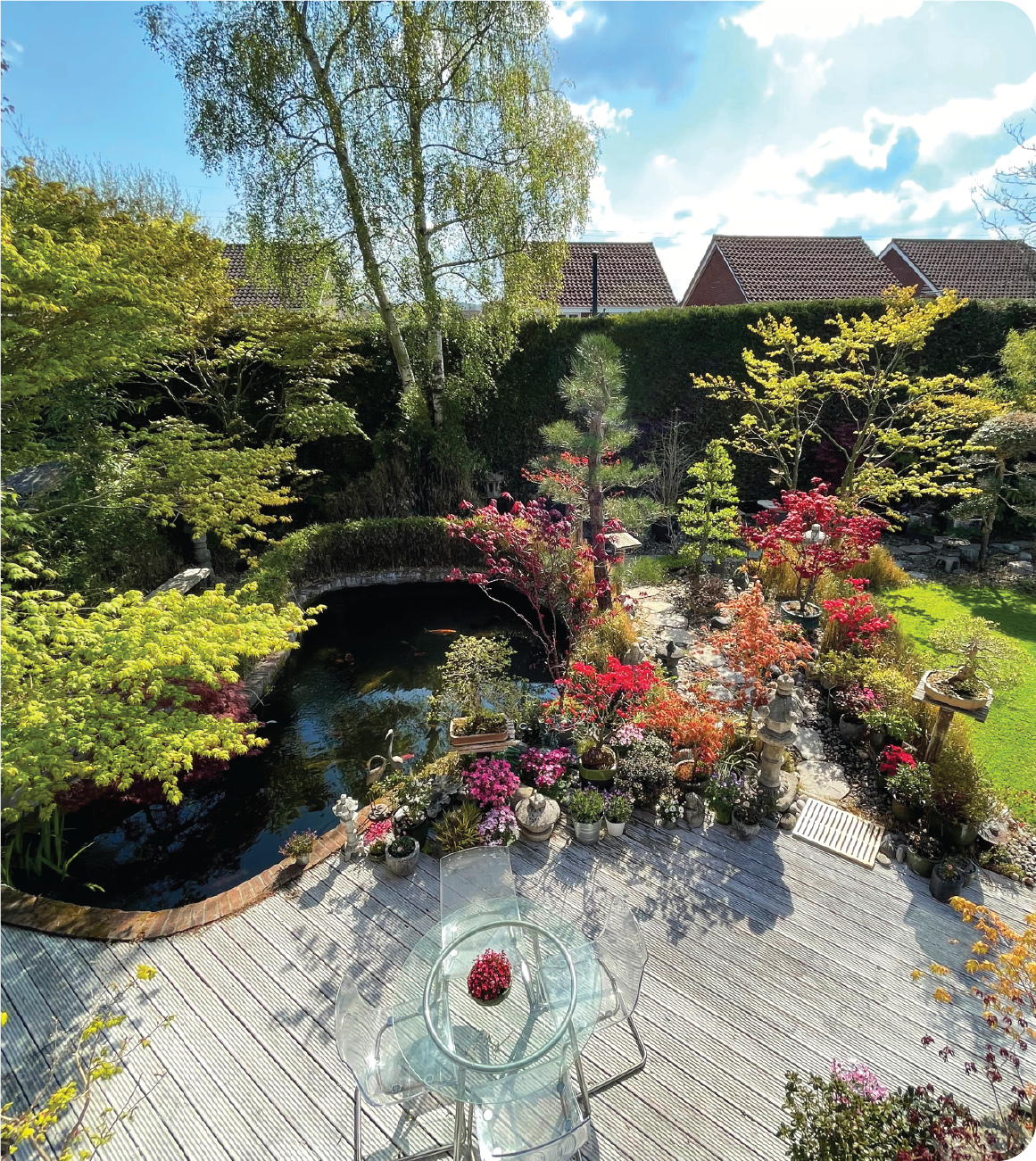 There is a table and chairs in the middle of the garden.