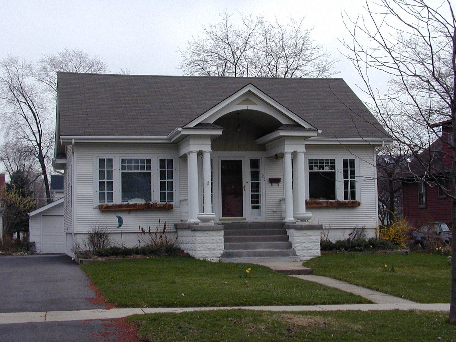 A small white house with a gray roof