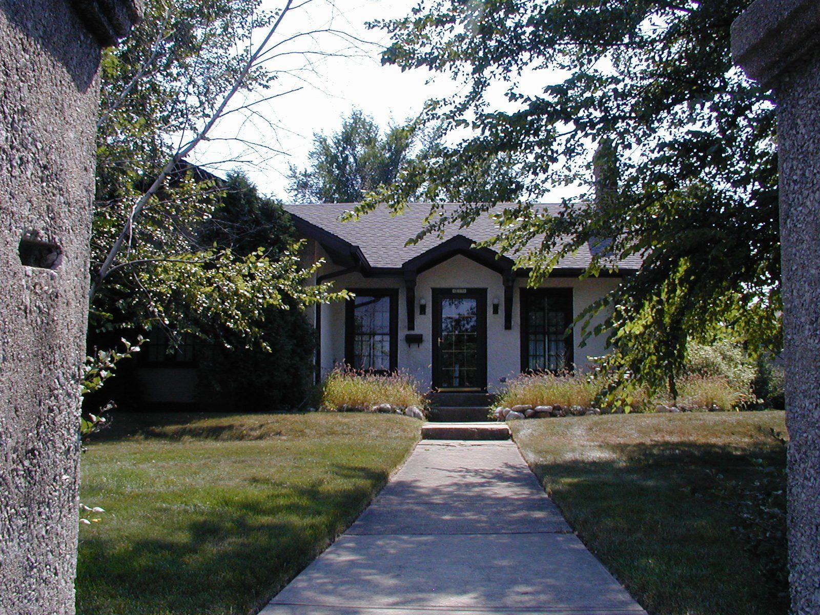 A house with a concrete walkway leading to it