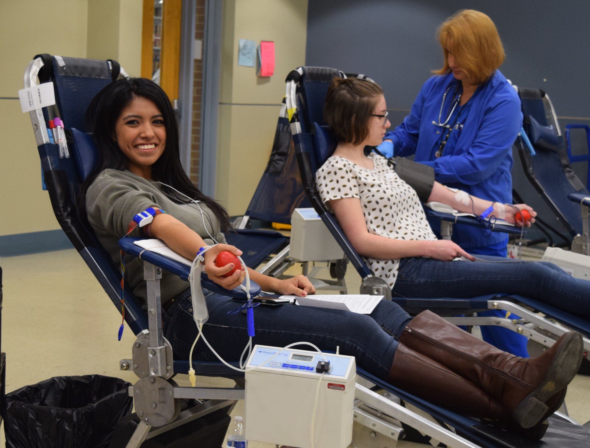 A woman is sitting in a chair with a red ball in her hand