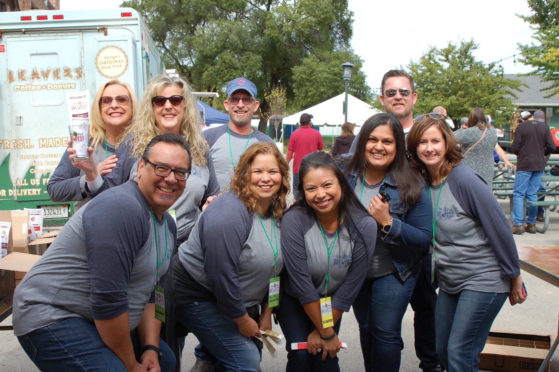 A group of people posing for a picture in front of a food truck that says beaver 's