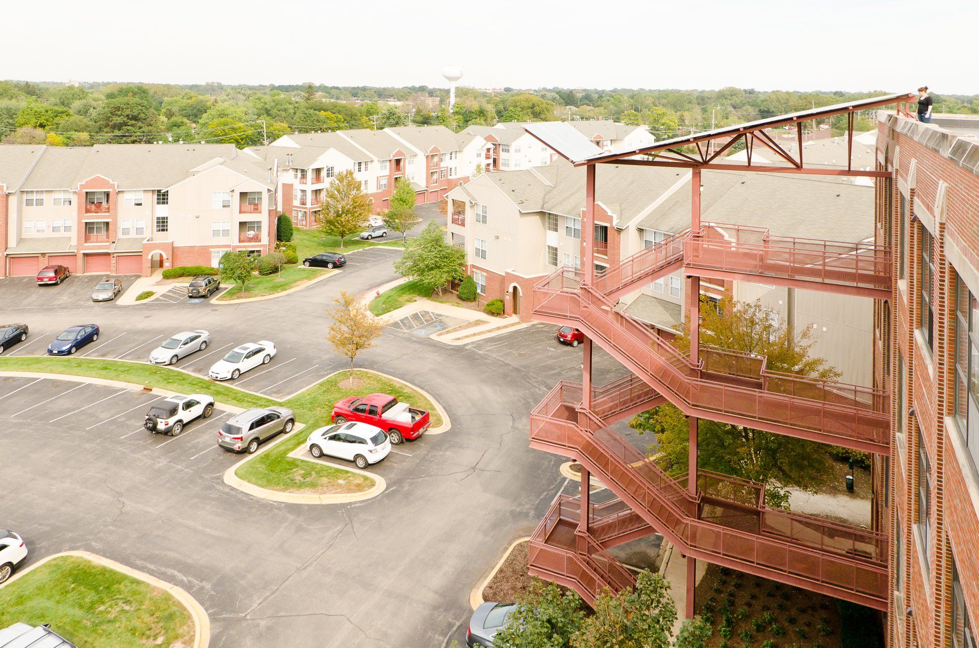 An aerial view of a parking lot and a building with stairs leading up to it.