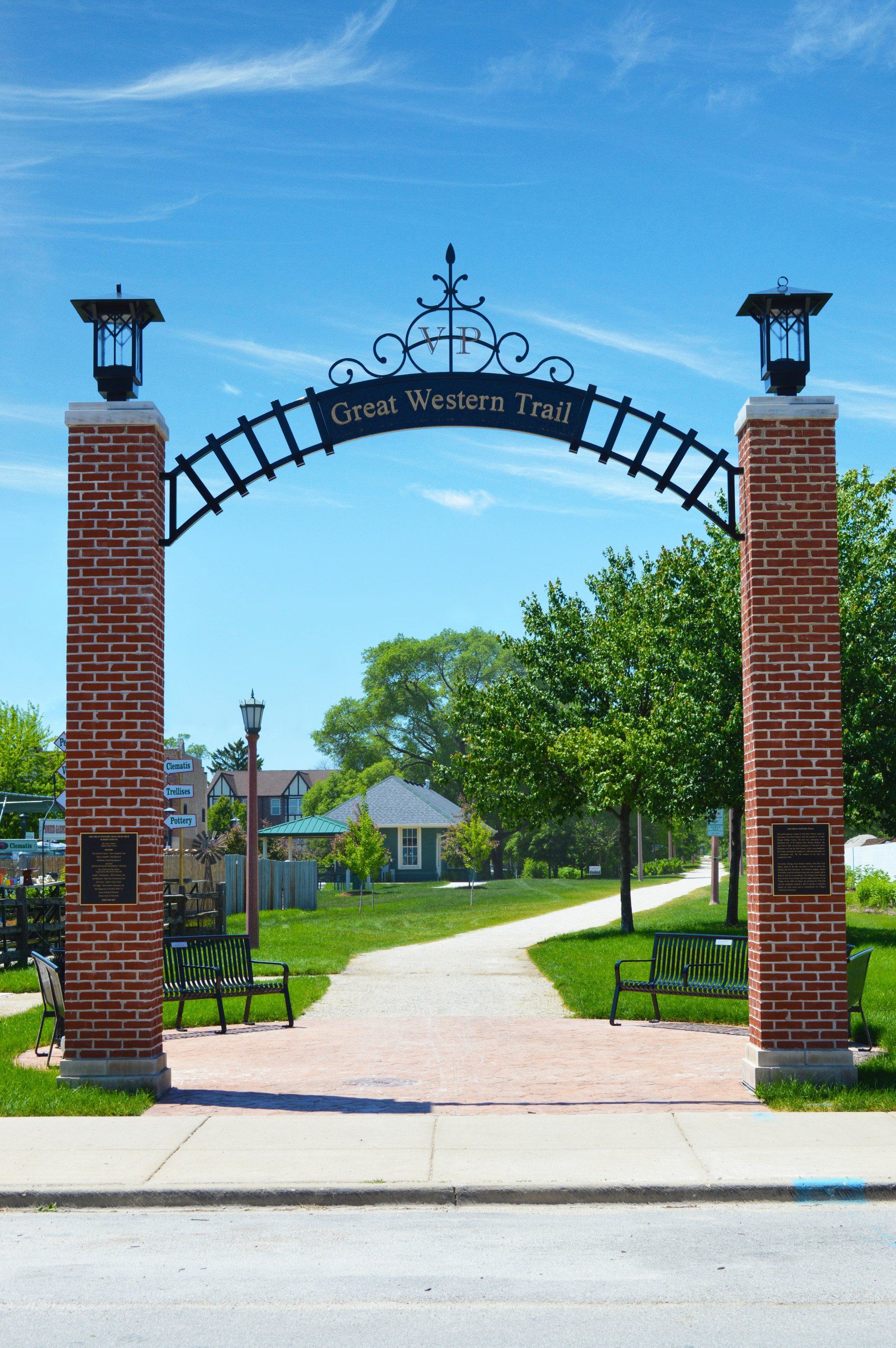 A brick archway with a sign that says great western trail