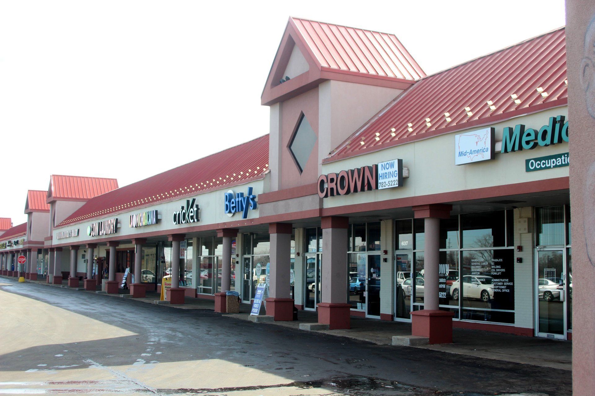 A row of shops with one that says crown