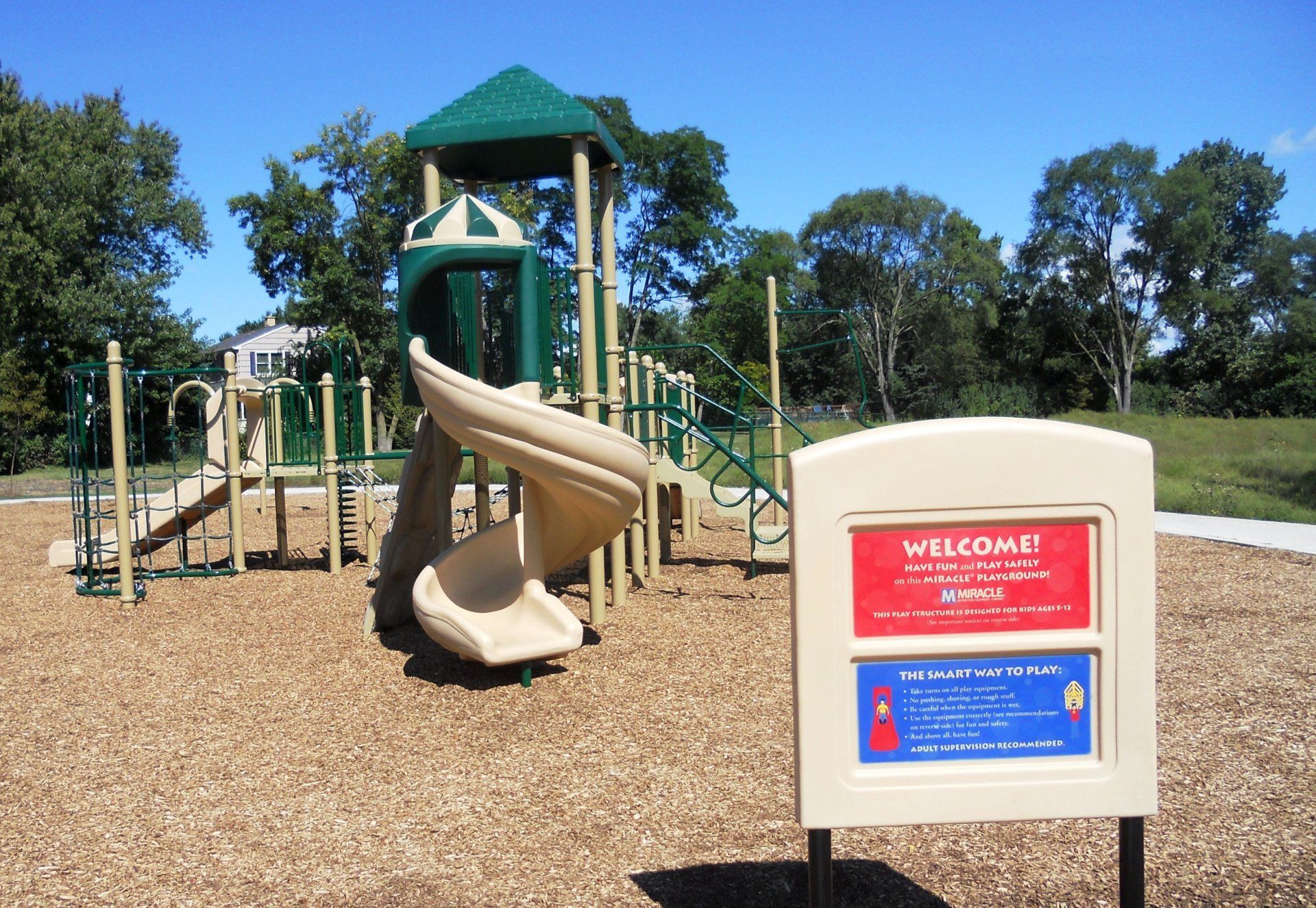 A playground with a welcome sign in front of it