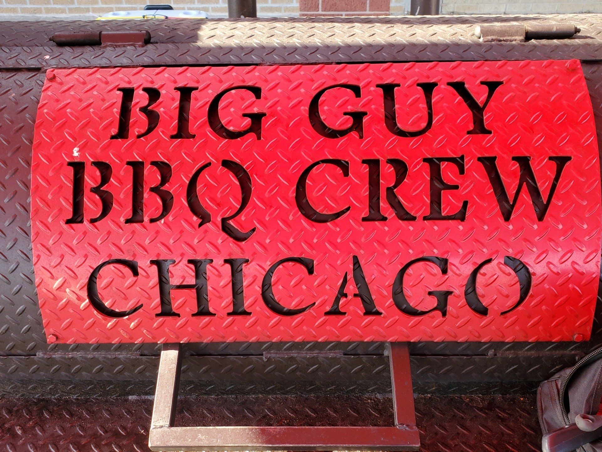 A red sign that says big guy bbq crew chicago