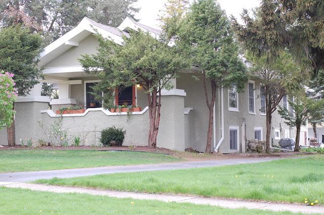 A house with a large lawn in front of it
