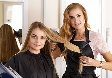 Women Haircuts — Staff Holding Clients Hair in Cocoa Beach, FL