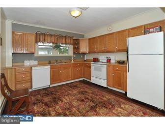 A kitchen with wooden cabinets and a white refrigerator