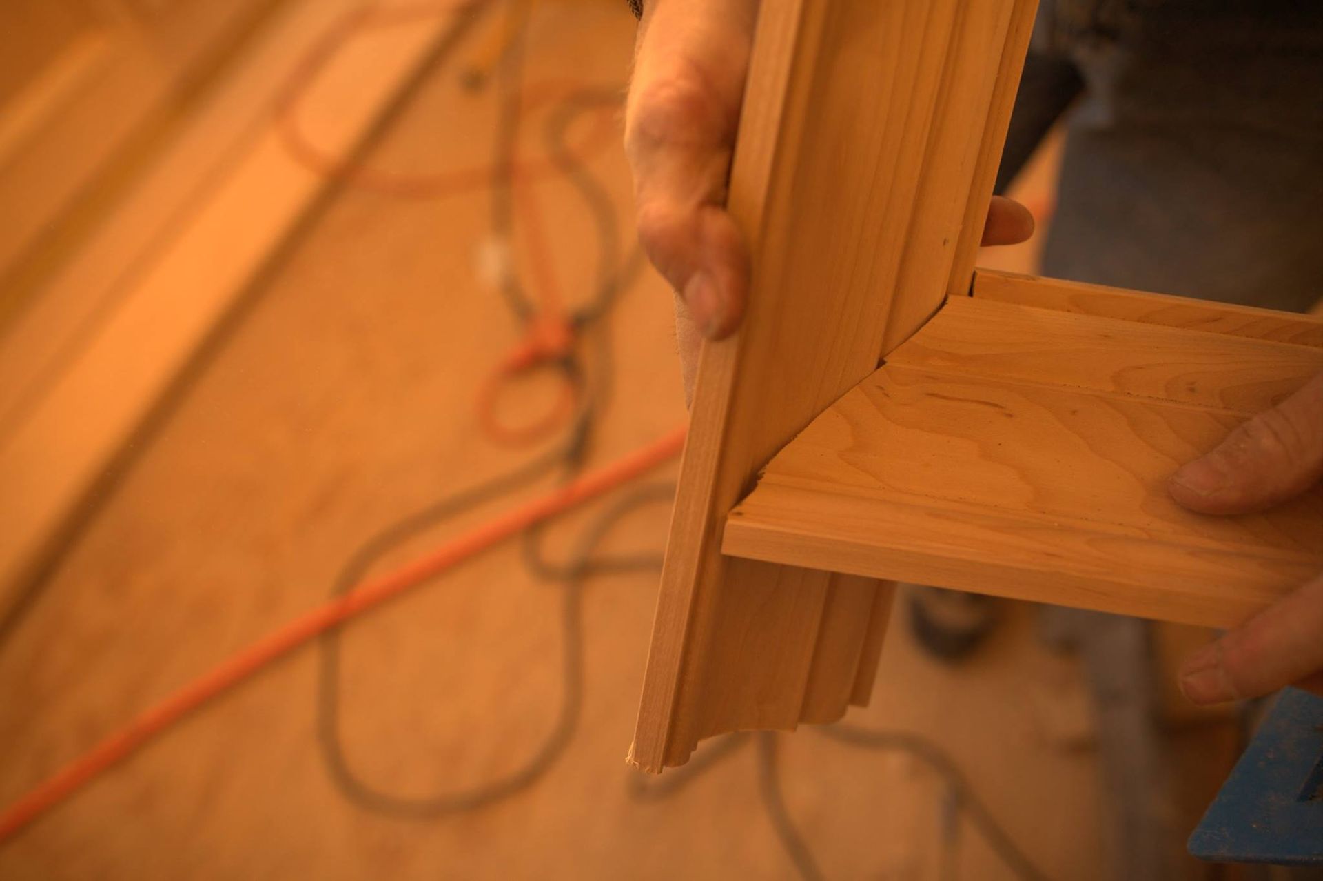 A person is holding a piece of wood in their hand.