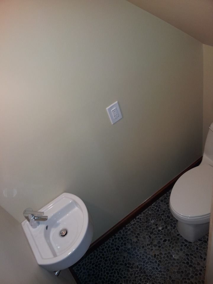 There is a toilet and a sink in the bathroom.