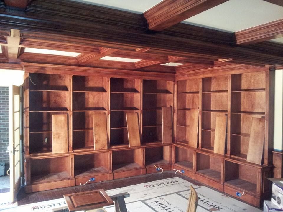 A room with a lot of wooden shelves in it