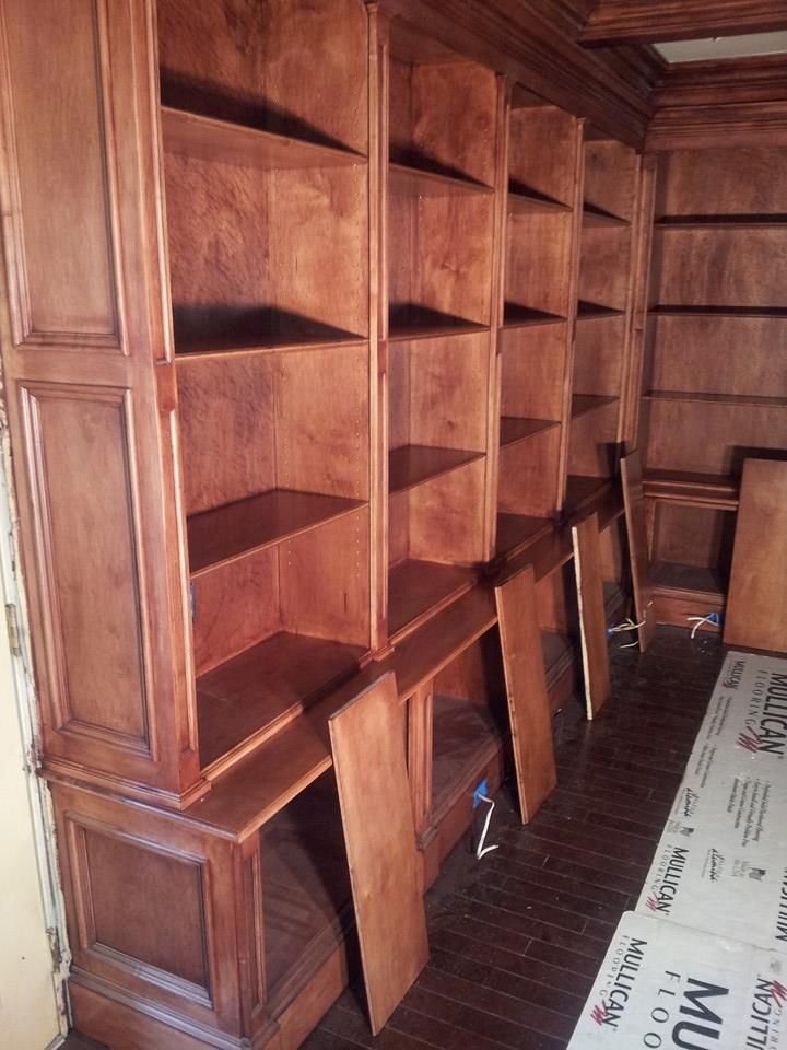 A room with wooden shelves and a sign that says mu