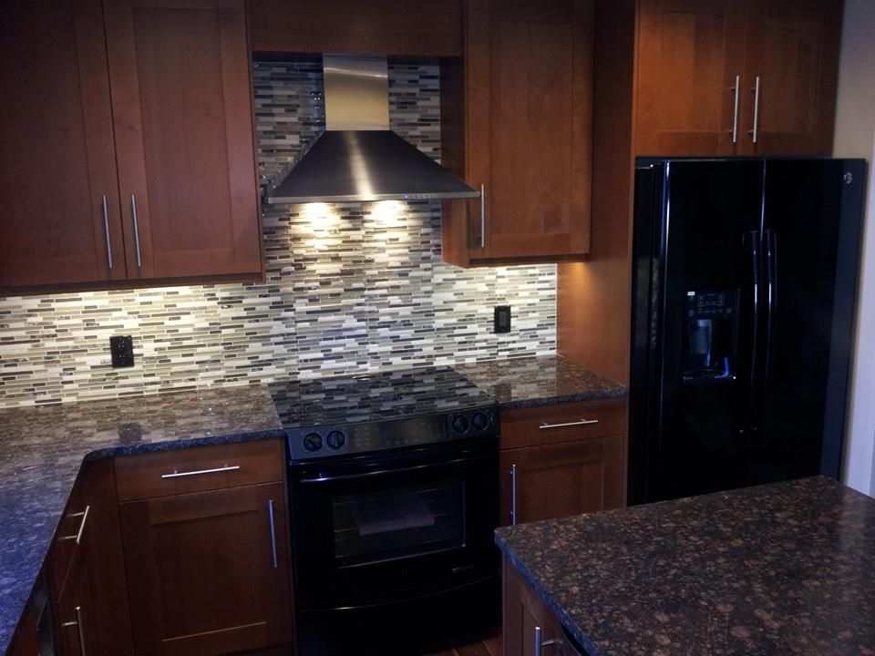 A kitchen with stainless steel appliances and wooden cabinets