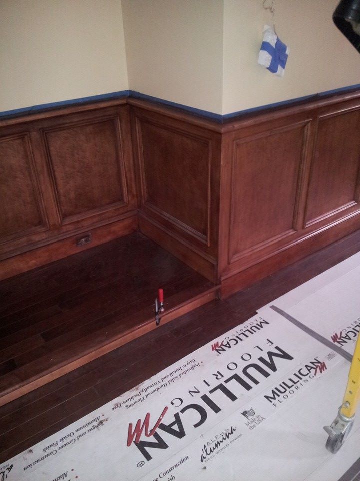 A room with wood paneling and mulligan flooring