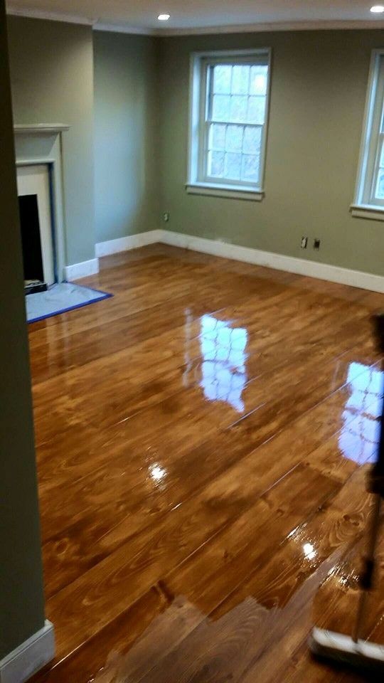 A living room with hardwood floors and a fireplace.