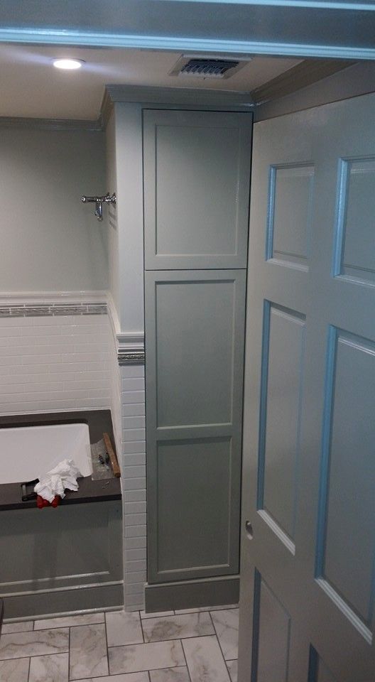 A bathroom with a bathtub and a door that is open.