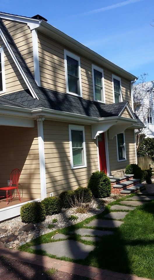 A house with a red door and a walkway leading to it
