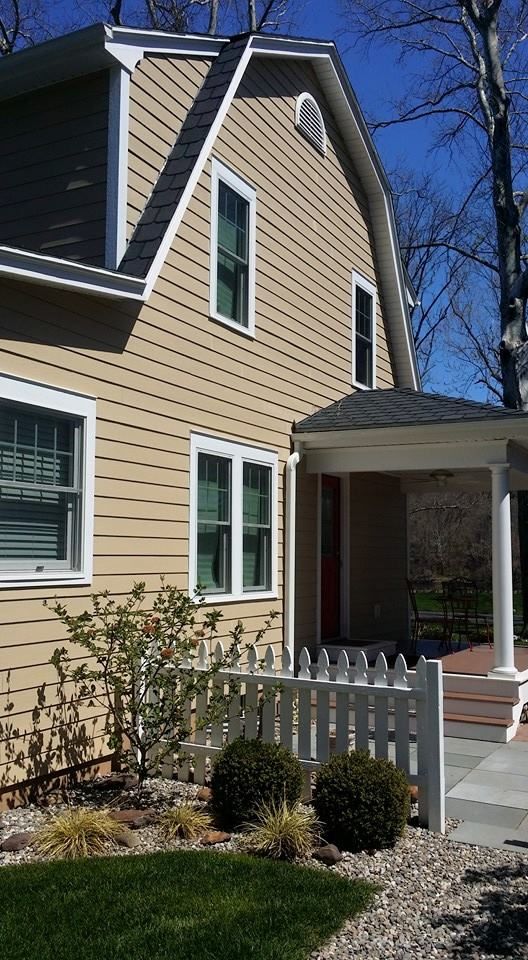 A house with a white picket fence in front of it