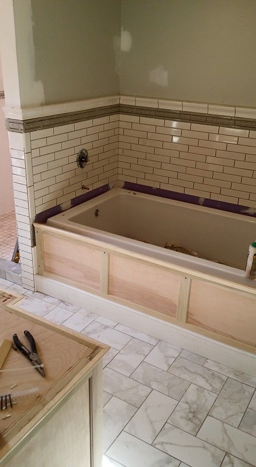 A bathtub is being built in a bathroom.