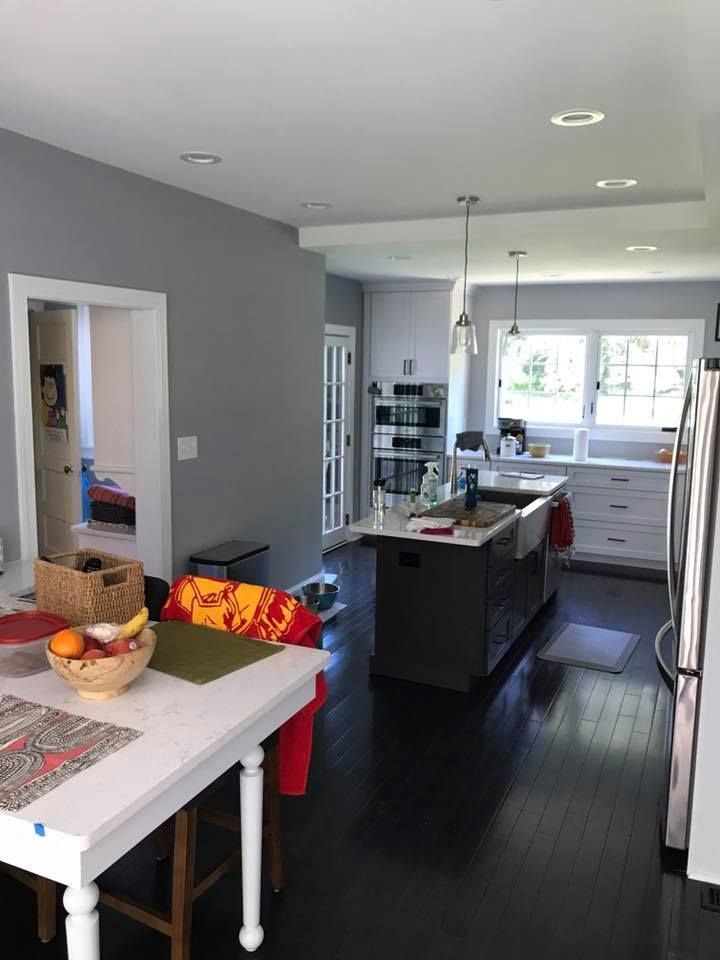 A kitchen with a large island and a white table
