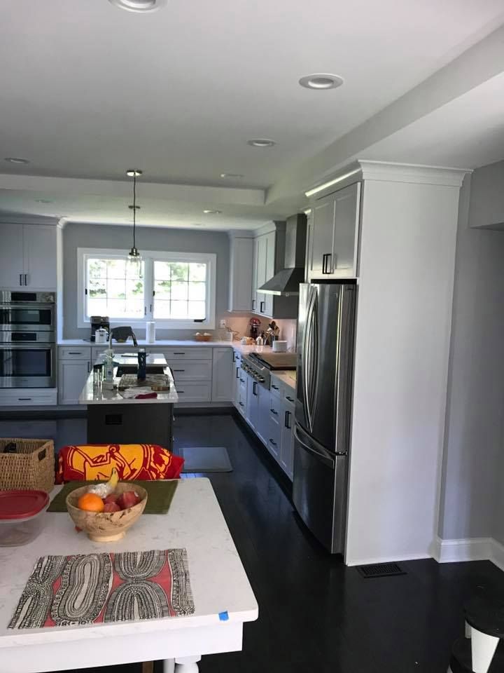 A kitchen with white cabinets and stainless steel appliances