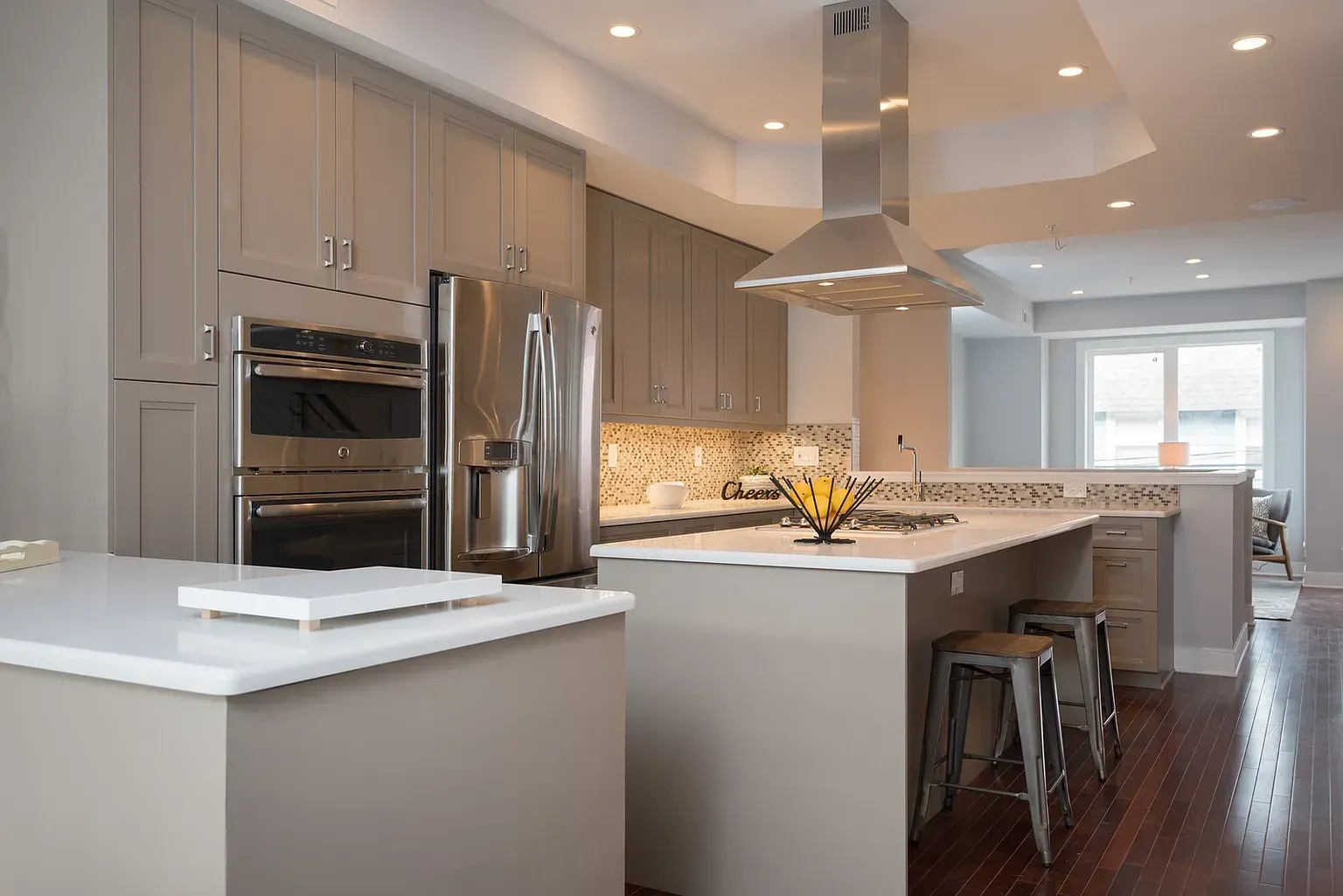 A kitchen with stainless steel appliances and a large island.