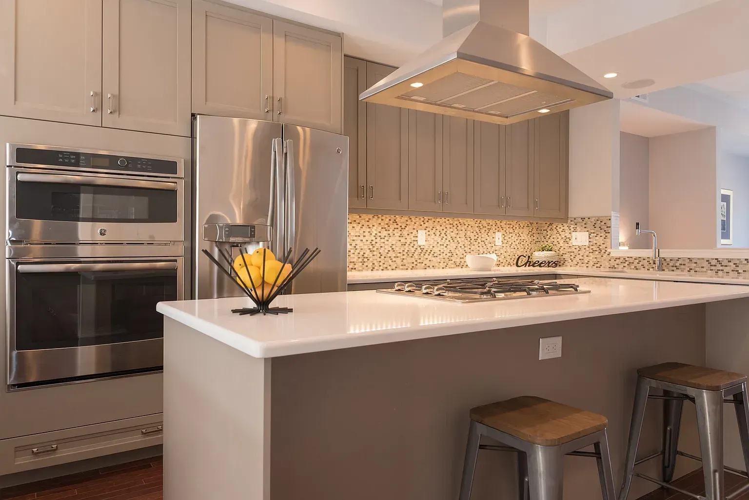 A kitchen with stainless steel appliances and a large island