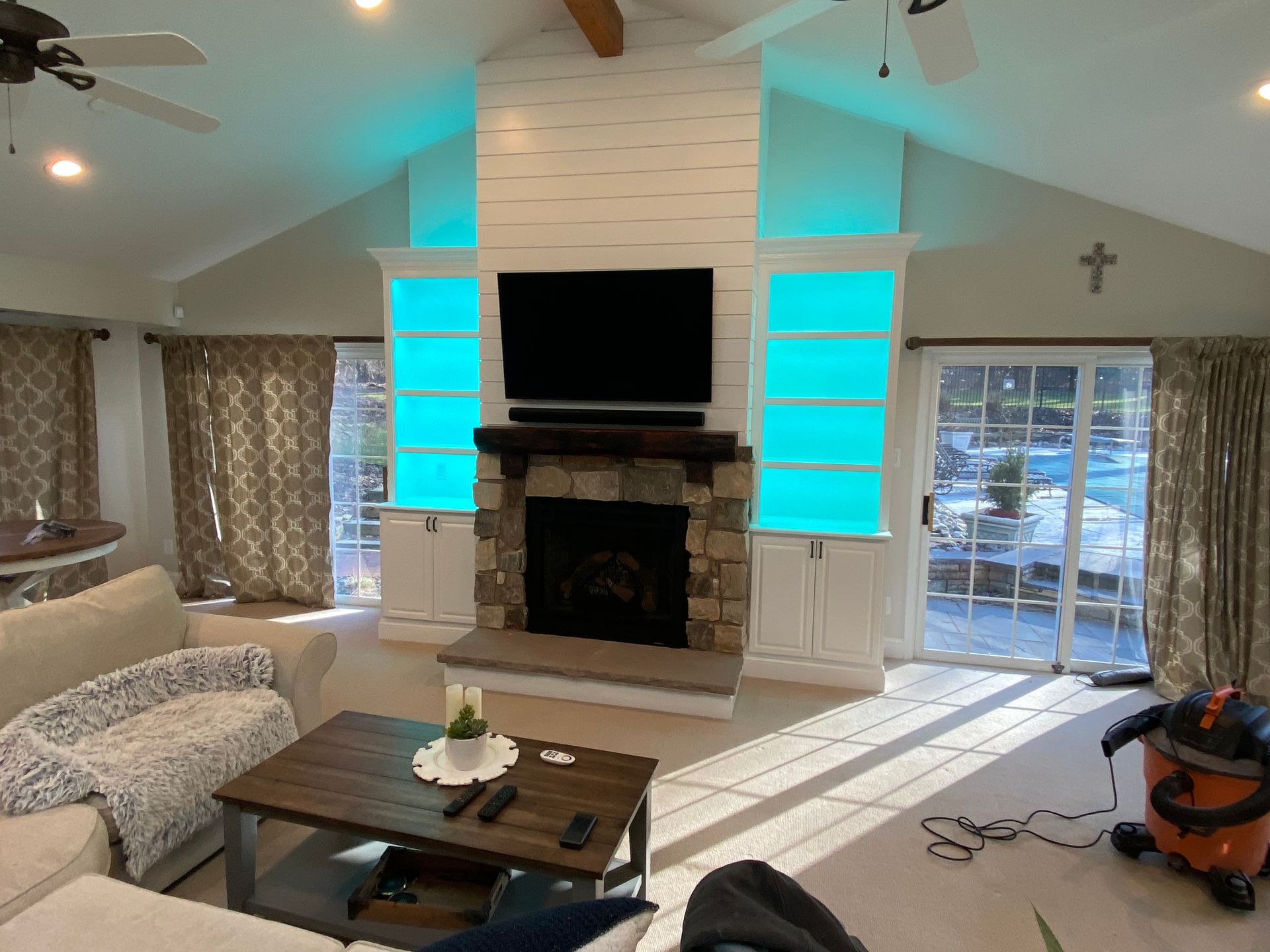 A living room with a fireplace and a flat screen tv