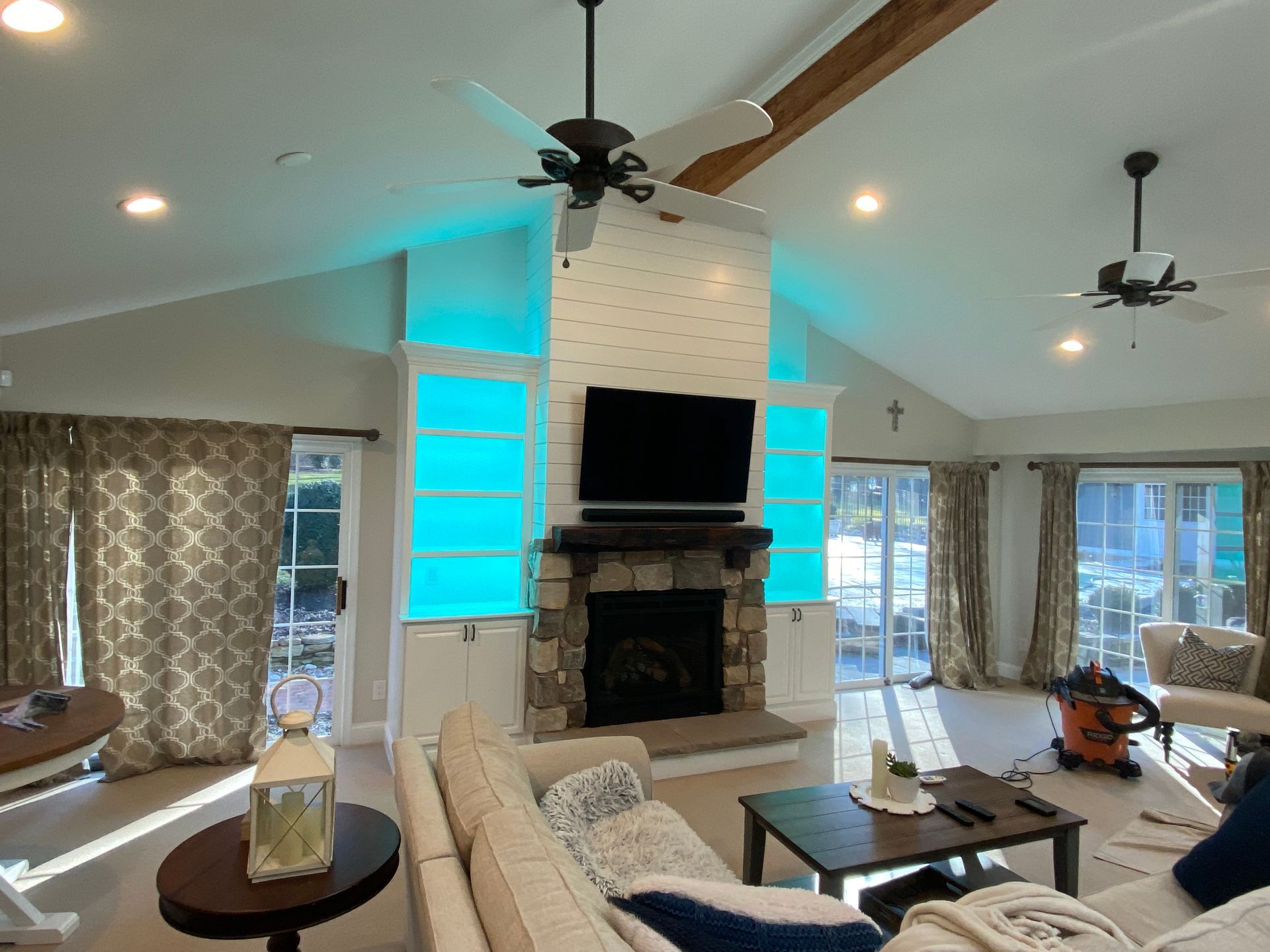 A living room with a fireplace and a flat screen tv