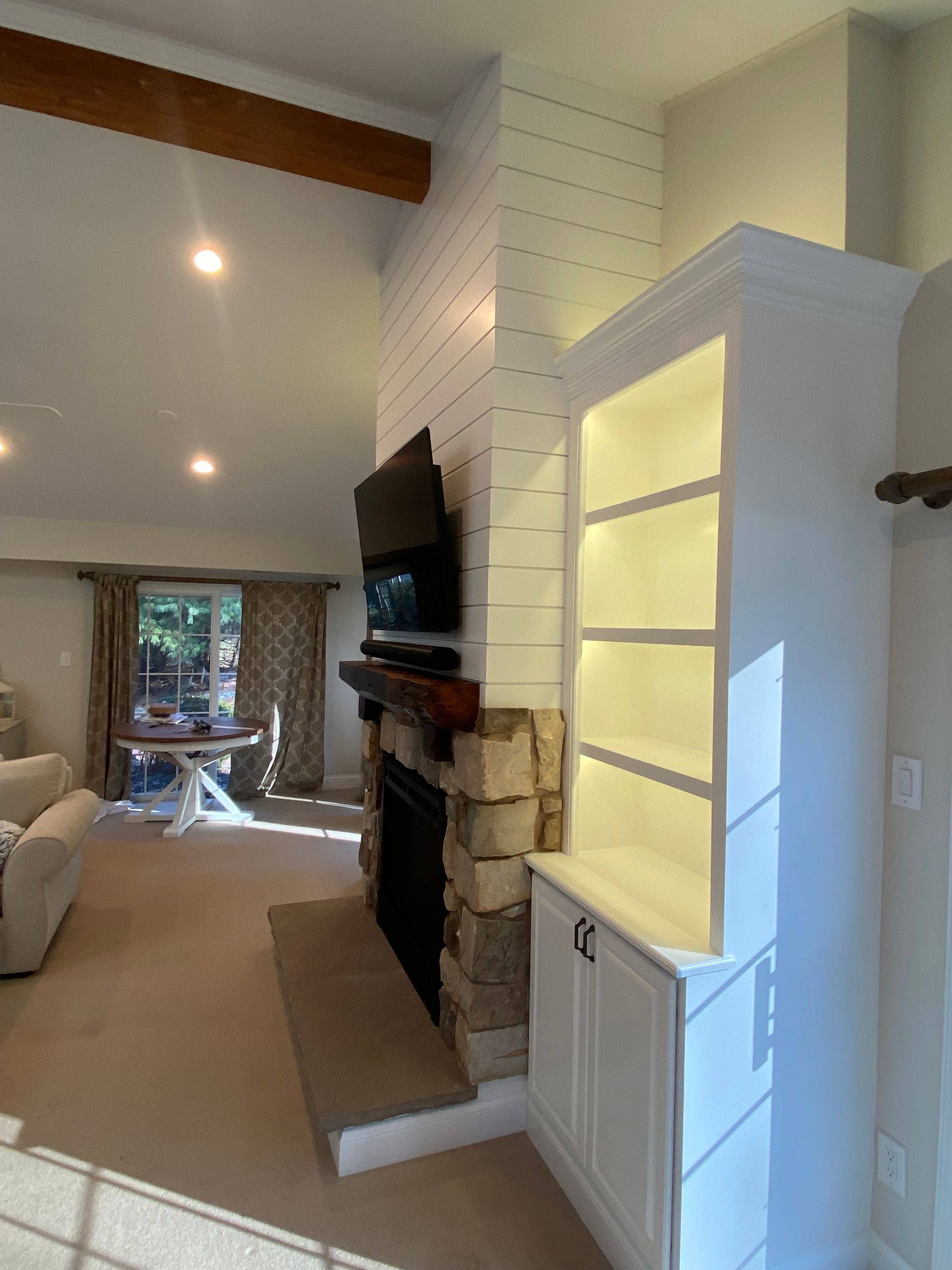 A living room with a fireplace and a tv