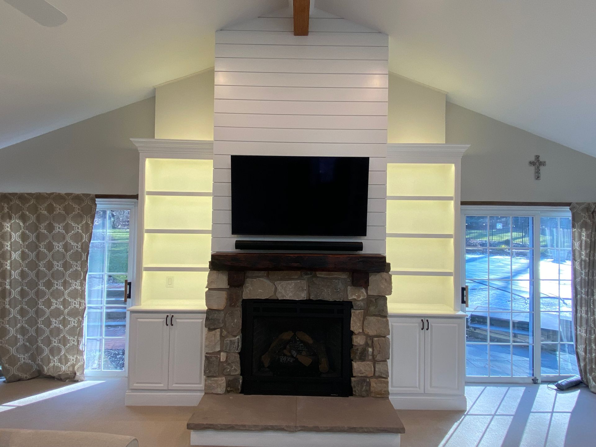 A living room with a fireplace and a flat screen tv