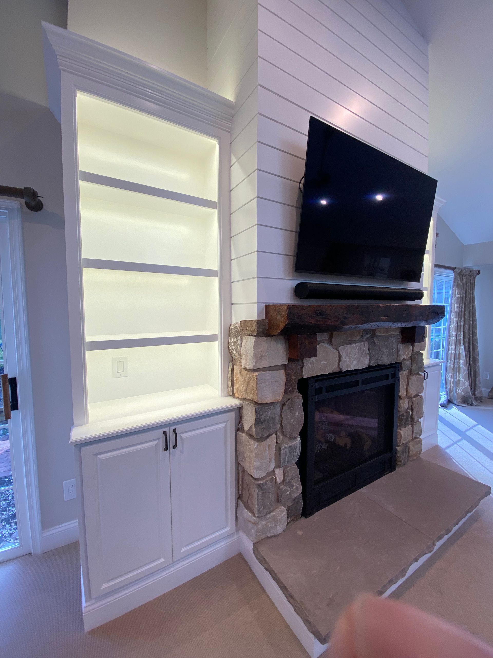 A living room with a fireplace and a flat screen tv