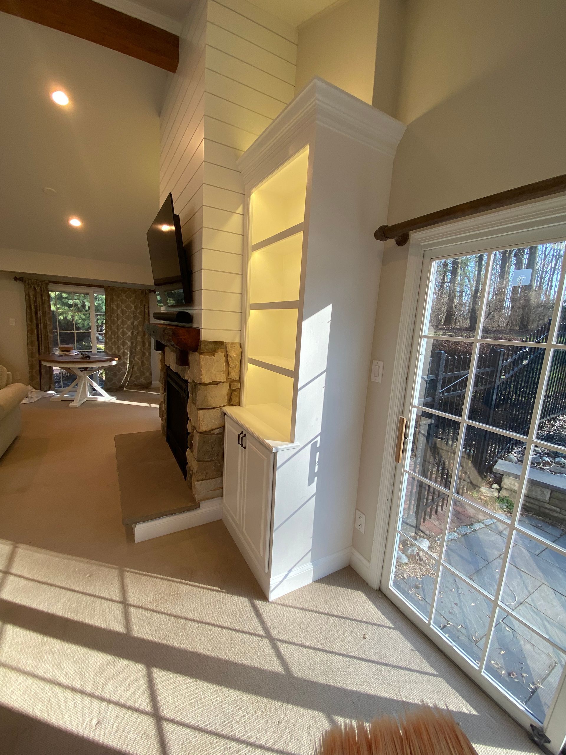 A living room with a sliding glass door and a fireplace