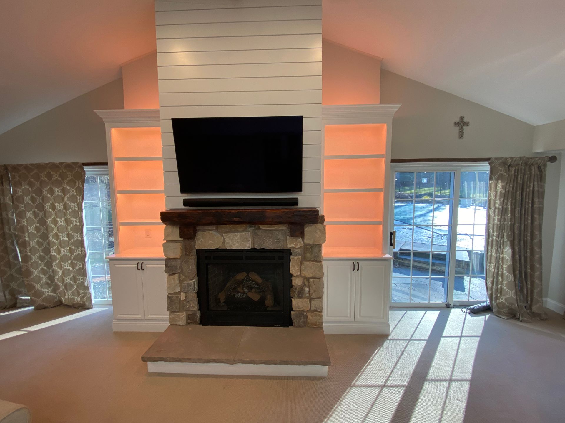 A living room with a fireplace and a flat screen tv.