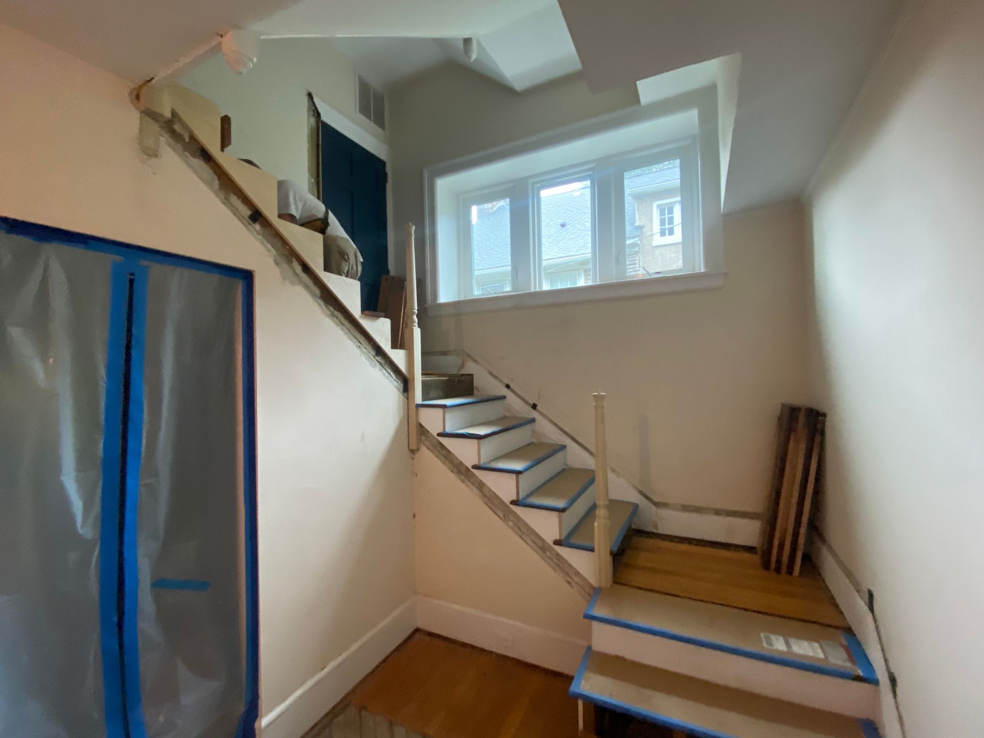 An empty room with stairs and a window