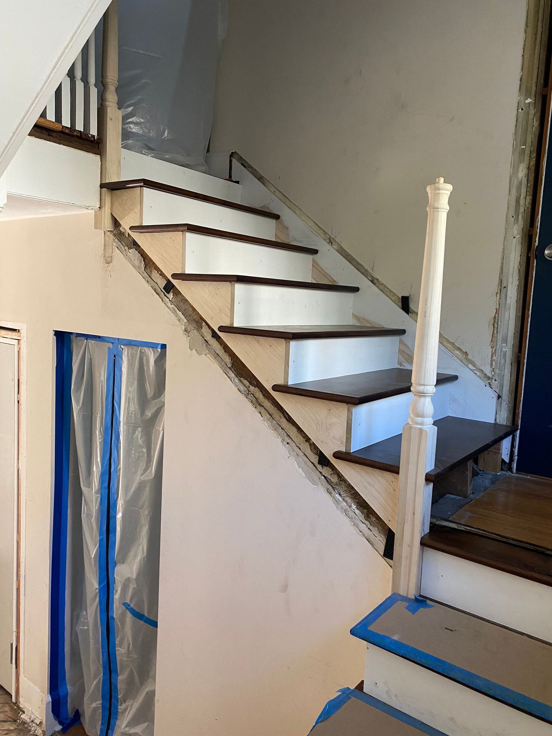 A staircase is being painted in a house