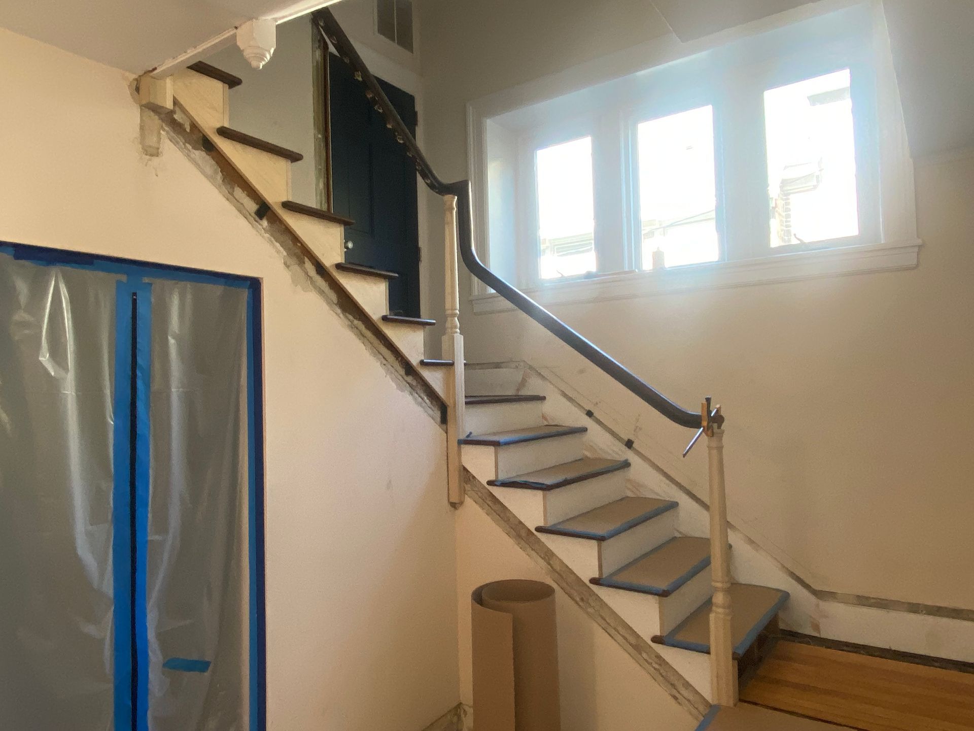A staircase in a house that is being painted