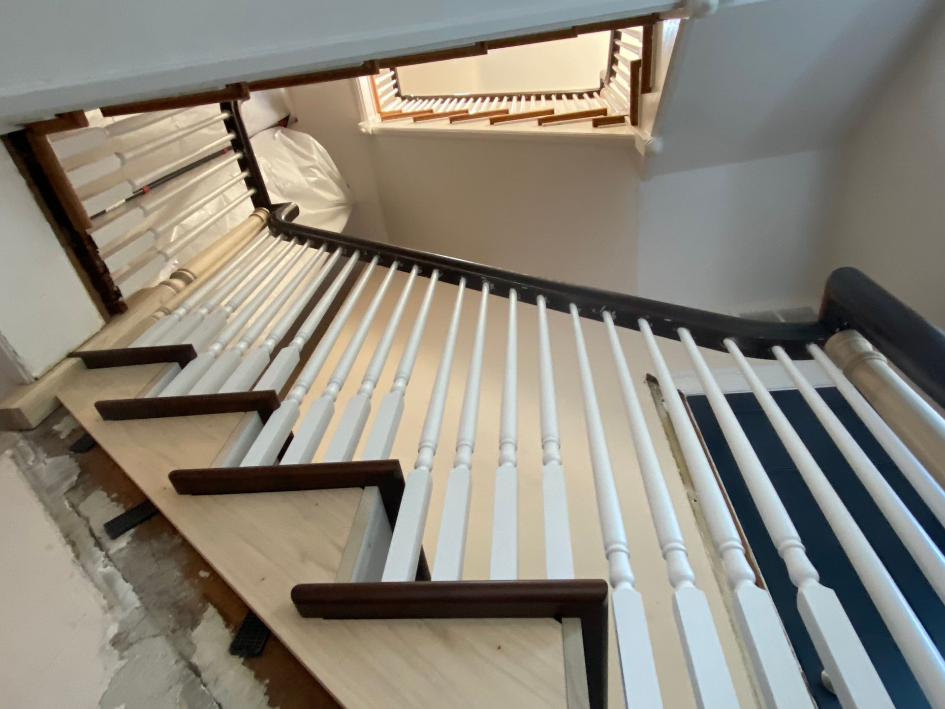 A staircase with white railings and wooden steps