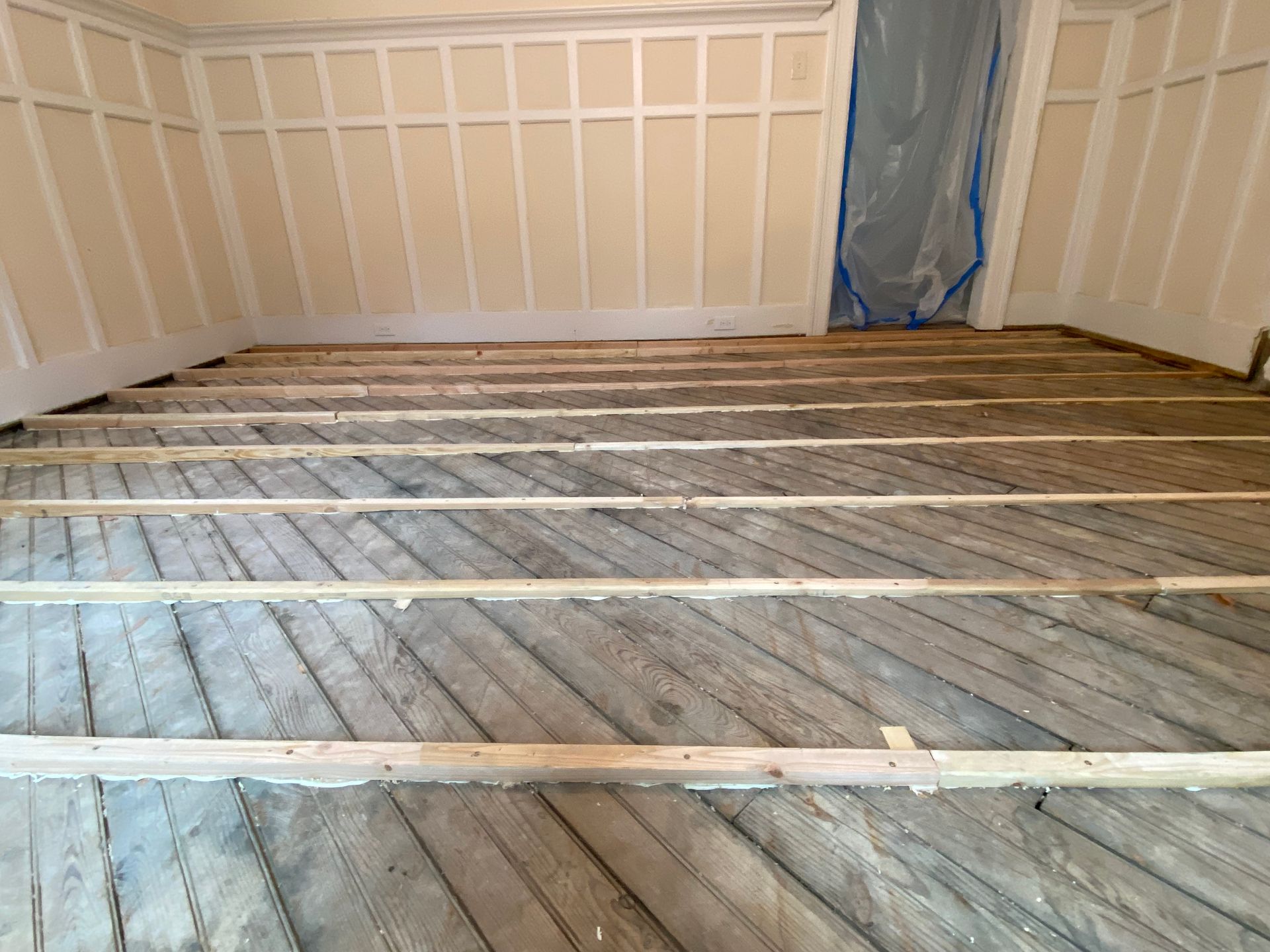 A room with a wooden floor and white walls